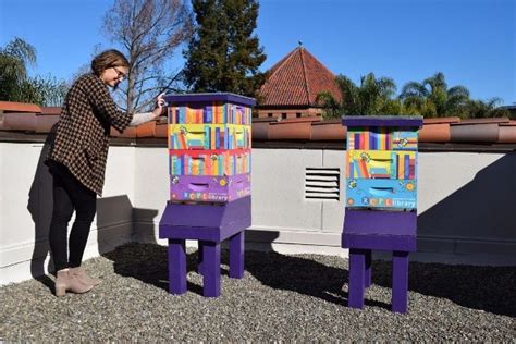 Librarian Jenny Barnes Inspects One Of Two Bee Hives On The Librarys