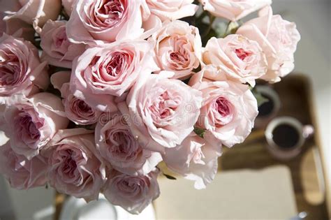 Bouquet Of Pink Roses In A Glass Vase With A White Teapot And Two