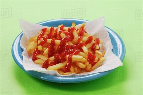 A Plate Of Chips With A Lot Of Ketchup Stock Photo Dissolve