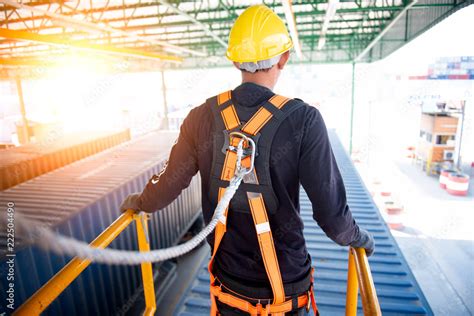 Construction worker use safety harness and safety line working on a new construction site ...