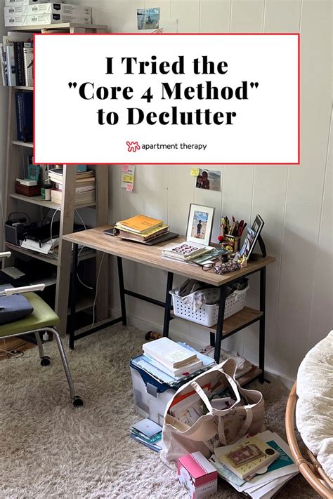 There Is A Pile Of Books On The Floor Next To A Desk With A Sign That