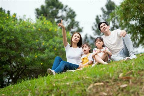 Young Asian family in the park 24704907 Stock Photo at Vecteezy