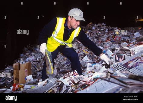 Worker Sorting Through Waste Paper For Recycling Stock Photo Alamy