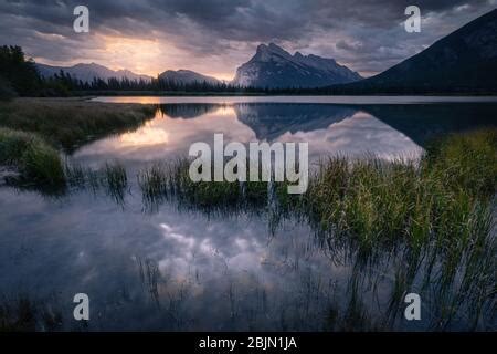 Sunrise In Banff National Park Dawn Glows In The Clouds Above Mount