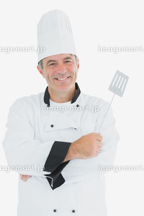 Portrait Of Happy Male Chef Holding Spatula Over White Background