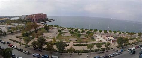 An Aerial View Of A Parking Lot Next To The Ocean With Cars Parked In It