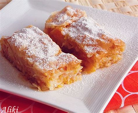 Two Pieces Of Dessert Sitting On Top Of A White Plate Next To A Red Napkin