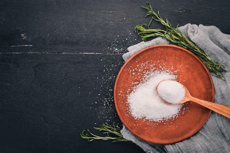 Premium Photo Salt In A Wooden Spoon On A Plate On A Wooden