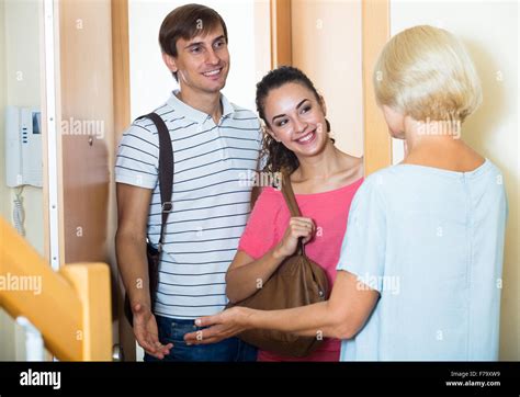 Happy Mature Mother Meets Son With His Wife At Doorway Stock Photo Alamy
