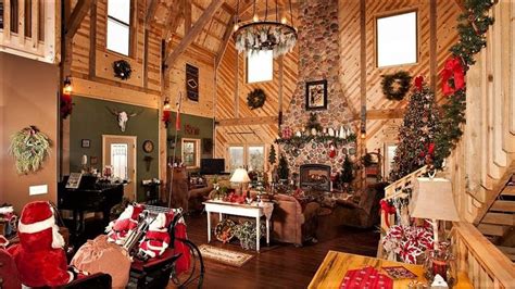 a living room filled with lots of furniture and christmas decorations ...