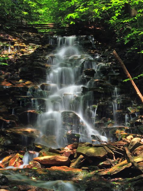 Time Lapse Photography Of Waterfall Falling From Layered Rocks In