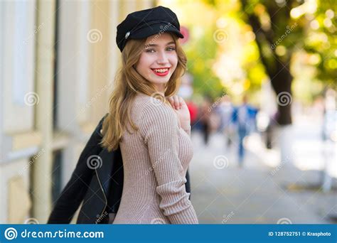 Beautiful Woman Walks Through City Streets Between Building Stock Image