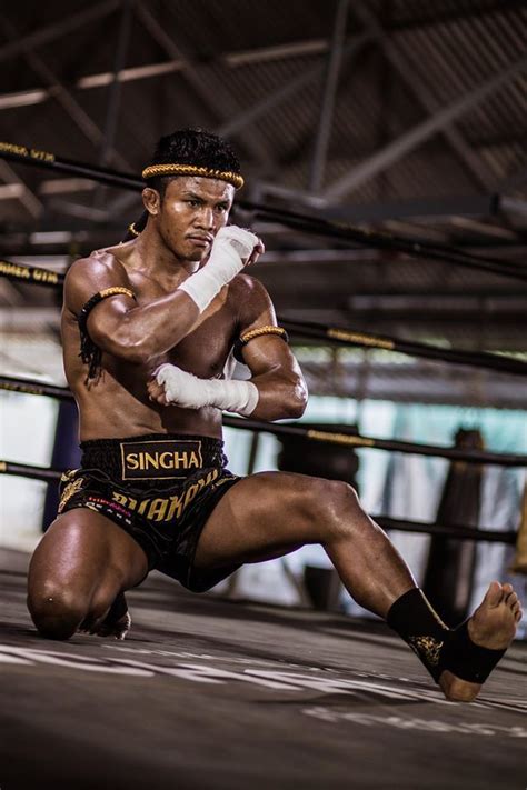 A Man Kneeling Down In The Middle Of A Boxing Ring