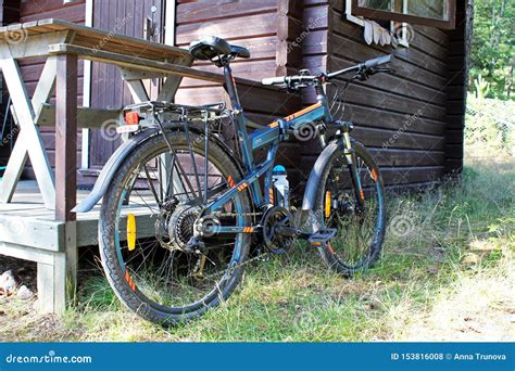 Sports Bike Parked Near A Wooden Country House In The Summer Stock