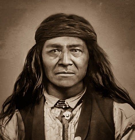 An Old Photo Of A Native American Man With Long Hair Wearing A Vest And Tie