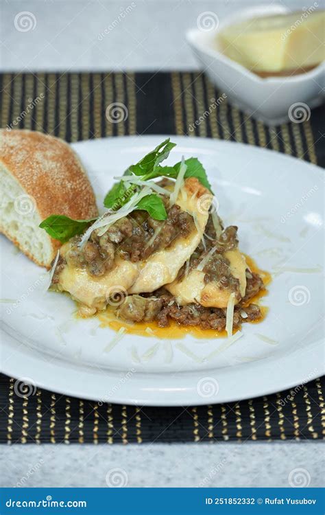 Fried Chicken Fillet With Mushrooms In Green Cheese Sauce Stock Photo