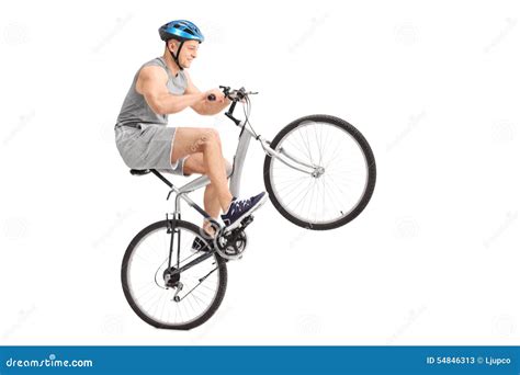 Joyful Young Biker Doing A Wheelie With His Bicycle Stock Image Image