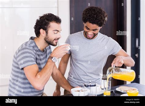 Happy Gay Couple Having Breakfast And Talking Stock Photo Alamy