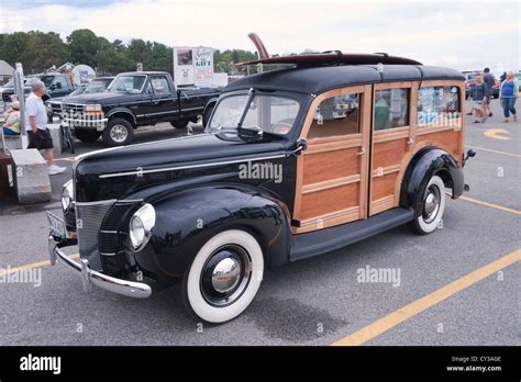 Ford Deluxe Vintage Woodie Station Wagon With Surfboard On The Top