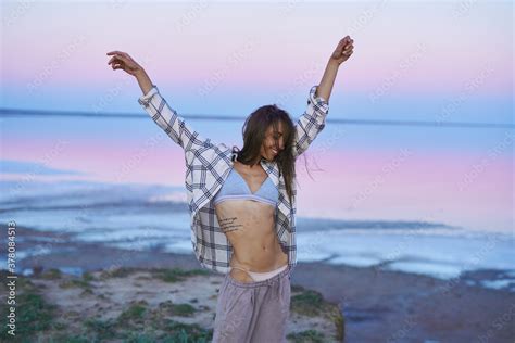 Sensual Brunette Perfect Slender Body Woman Posing On Pink Lake With Naked Belly At Evening