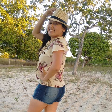 A Woman In Short Shorts And A Hat On The Beach