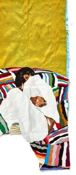 A Woman Laying On Top Of A Colorful Blanket