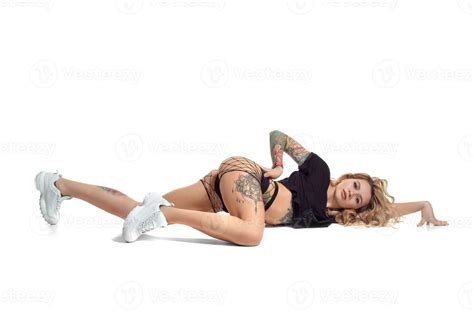 Beautiful Blonde Girl In Booty Shorts And Fishnet Dancing Twerk Isolated On White Background