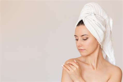 Premium Photo Nude Woman With White Towel Wrapped Around Her Head Gently Touching Her Shoulder