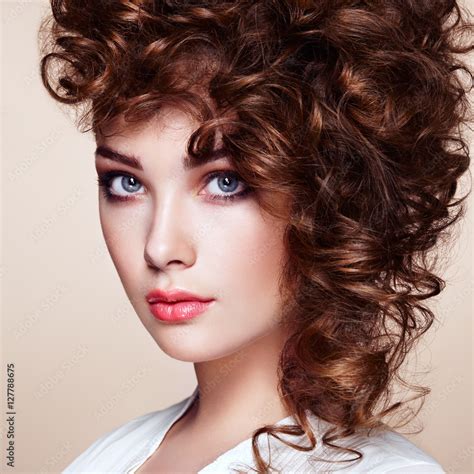 Brunette Woman With Curly And Shiny Hair Beautiful Model With Wavy Hairstyle Fashion Photo