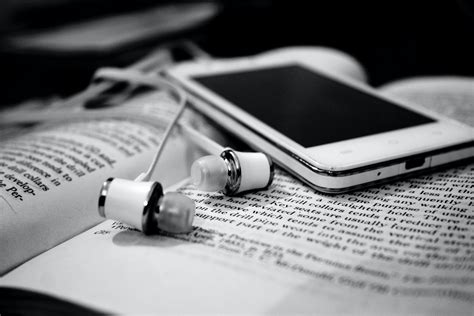 Free stock photo of black and white, books, earphones