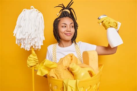 Premium Photo Satisfied Female Cleaner Keeps Cleaning Detergent In