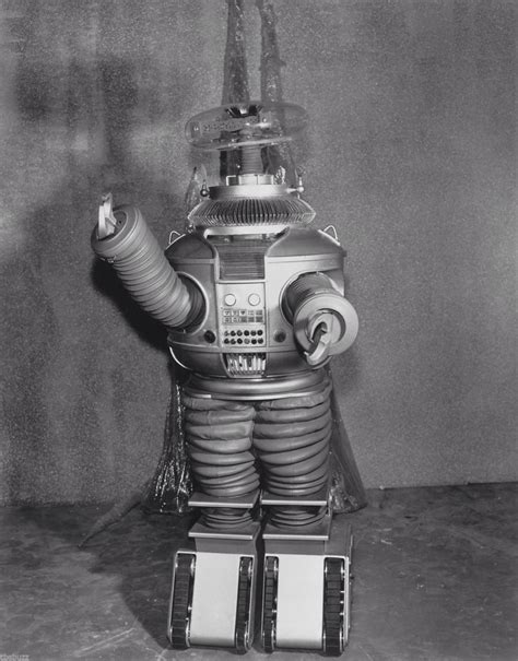 an old photo of a robot that is standing up