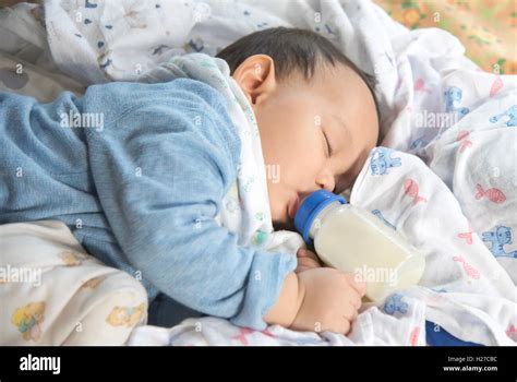 Asian Baby Sleeping And Drinking Milk From The Bottle Stock Photo Alamy