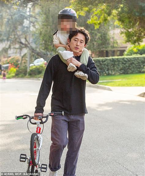 Steven Yeun Is Every Inch The Doting Father As He Carries His Toddler