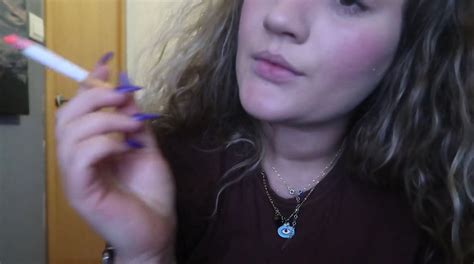 CLOSE UP CIGAR SMOKE BY A BEAUTY BLONDE WOMAN