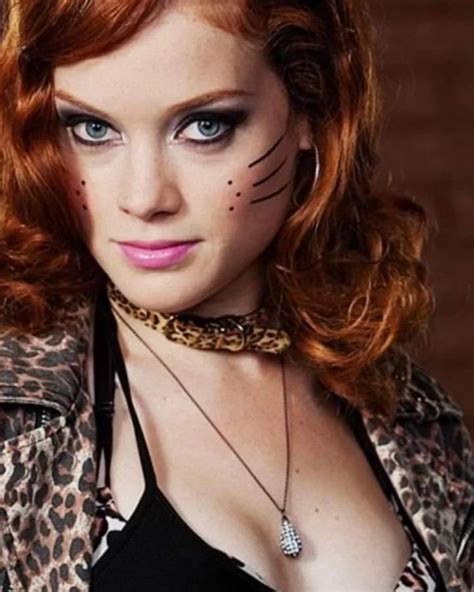 A Woman With Red Hair And Cat Makeup