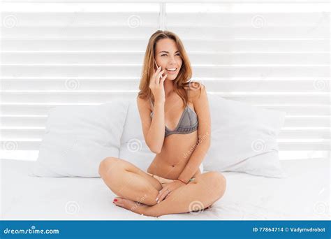 Attractive Smiling Girl In Bikini Talking On The Phone Stock Photo