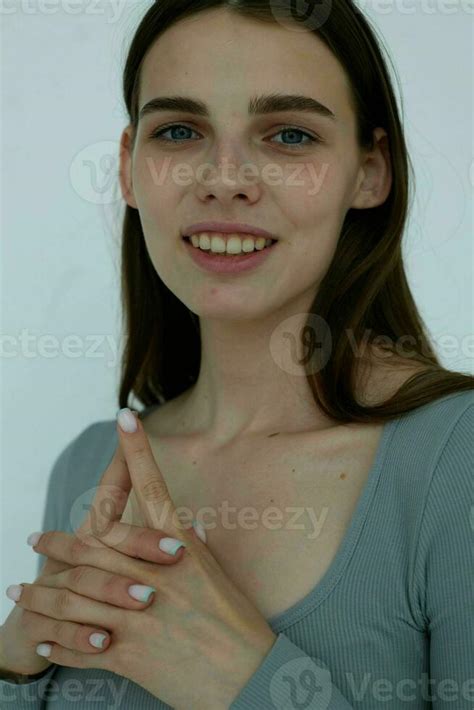 Cheerful Brunette Gesturing With Her Hands Close Up Light Background