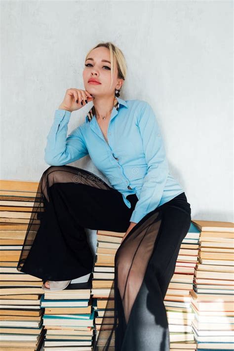 Beautiful Blonde Woman Sitting On Stacks Of Books In Library Stock Photo Image Of Library