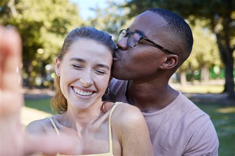 Premium Photo Love Kiss And Selfie With Interracial Couple At Park