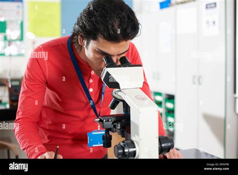 Chemistry student using microscope in laboratory Stock Photo - Alamy