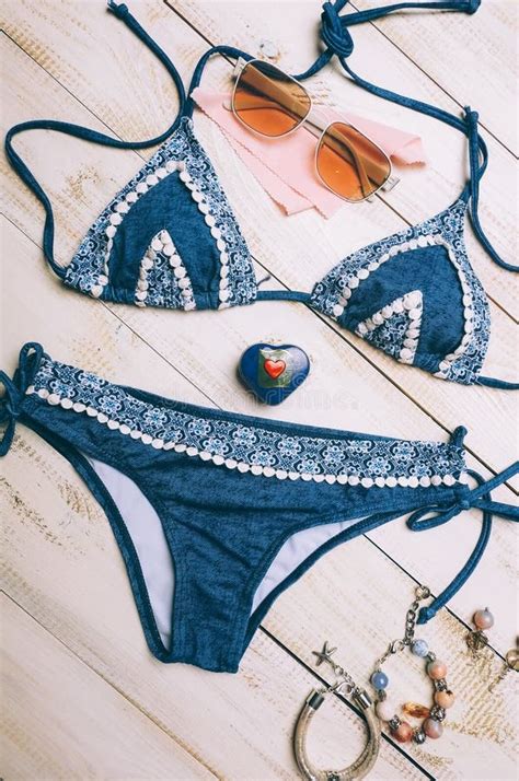 Flat Lay Of Summer Fashion With Blue Bikini Swimsuit And Girl Accessories On White Wooden