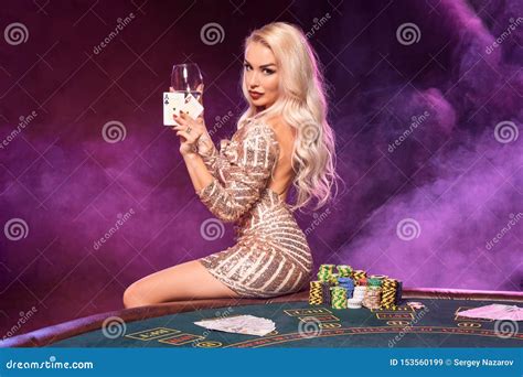 Blonde Woman With A Perfect Hairstyle And Bright Make Up Is Posing With Playing Cards In Her