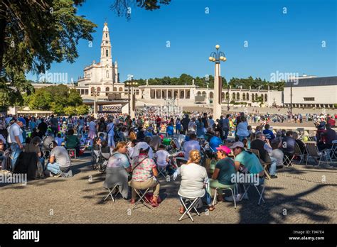 Fatima, Portugal - May 12, 2019: View of the Shrine of Fatima with pilgrims in foreground and ...