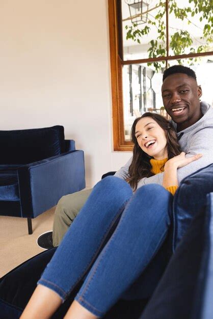 Premium Photo Portrait Of Happy Diverse Couple Sitting On Sofa