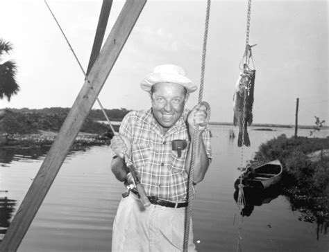 Florida Memory • Fisherman Proudly Displaying His Bass Catch Orange