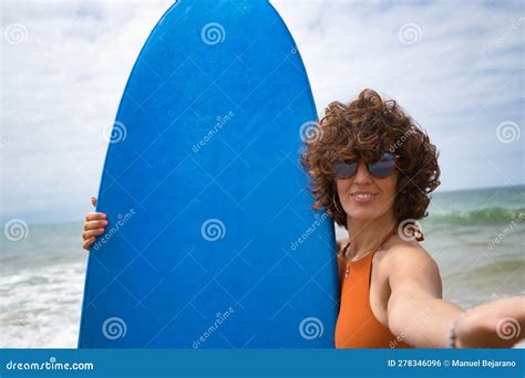 Attractive Mature Woman With Curly Hair Sunglasses And Bikini Taking