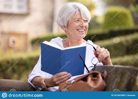 Attractive Mature Woman Reading Book In Park Stock Photo Image Of