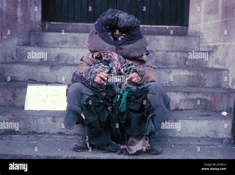 Homeless Person with begging sign Stock Photo - Alamy