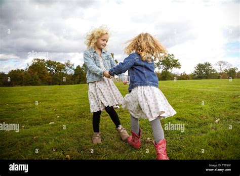 Two Sisters Holding Hands Hi Res Stock Photography And Images Alamy